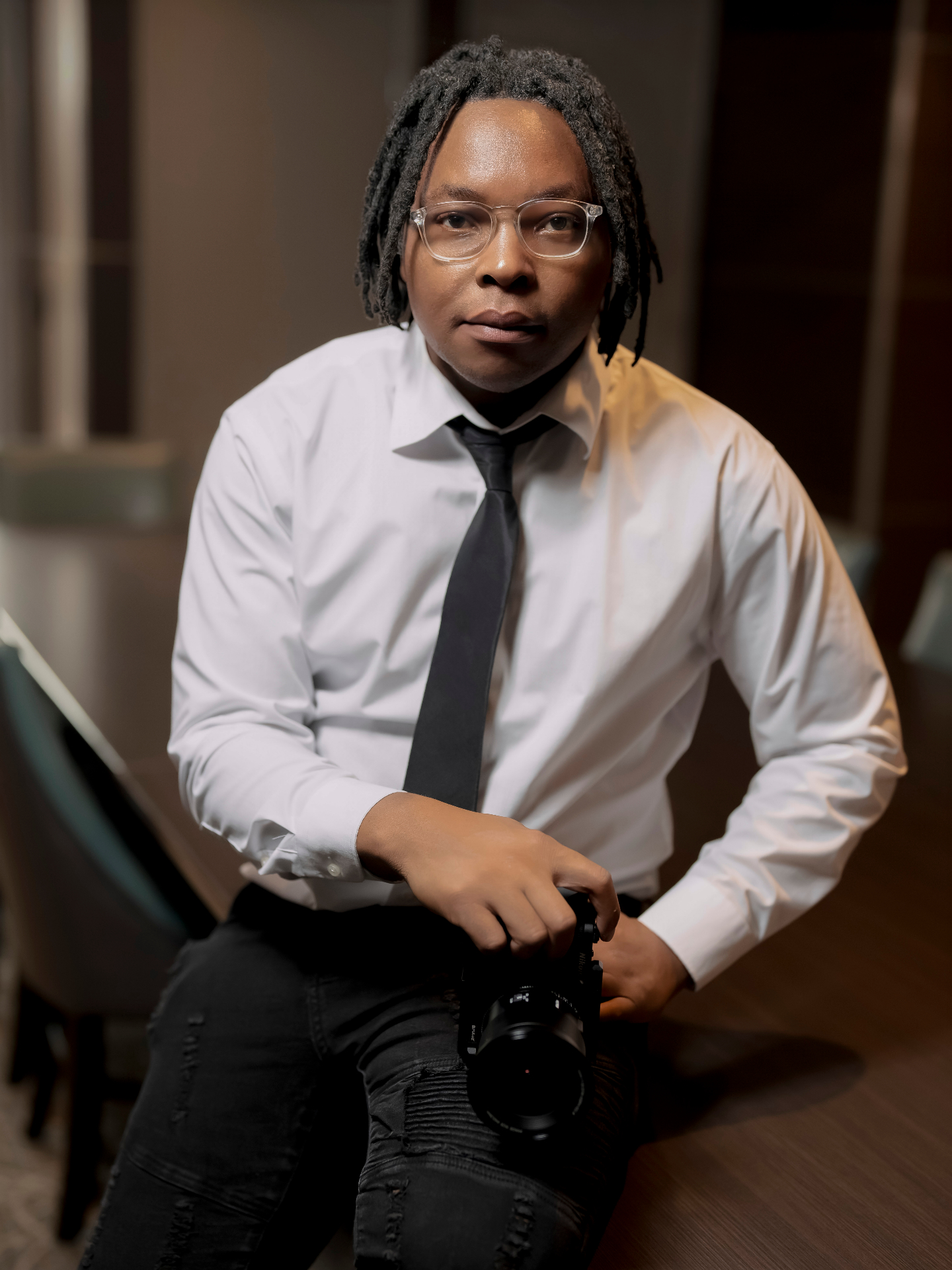 Chipiliro Khonje, Chicago luxury wedding and editorial photographer, seated portrait